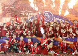 Liverpool players lifting the Premier League trophy after winning the 2019-20 title